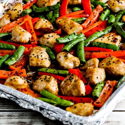 chicken stir fry in a foil wrapped sheet pan