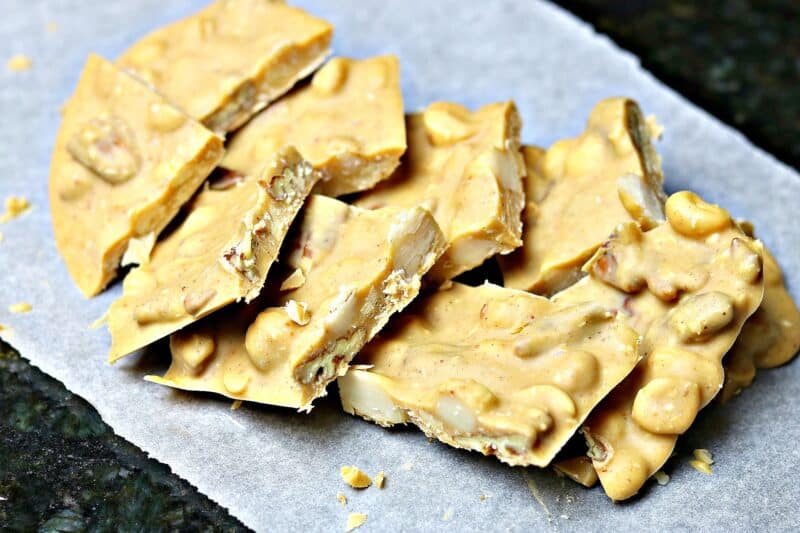 a close-up of chocolate mixed nut and peanut clusters recipe on parchment paper