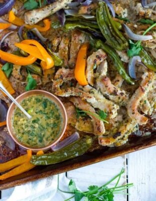 pork fajitas on a sheet pan with vegetables