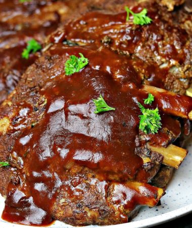 keto ribs on a plate with bbq sauce and parsley