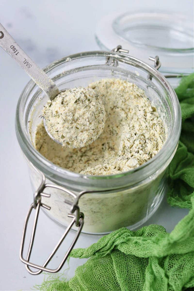 homemade keto ranch seasoning mix in a glass jar with a measuring spoon