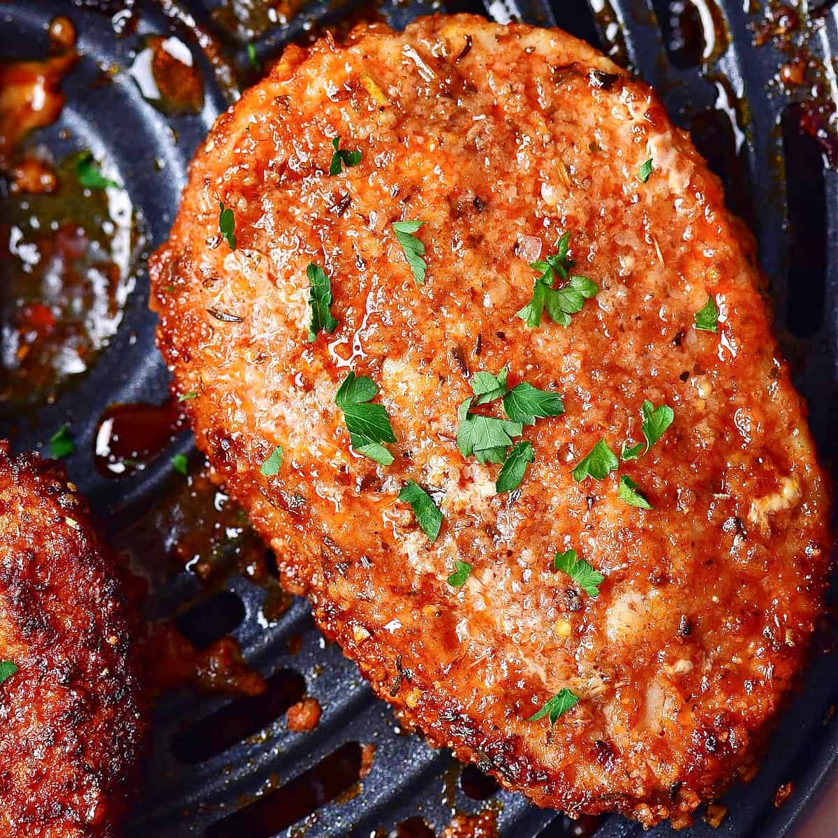 crispy air fryer pork chops in the Ninja Foodi air fryer basket