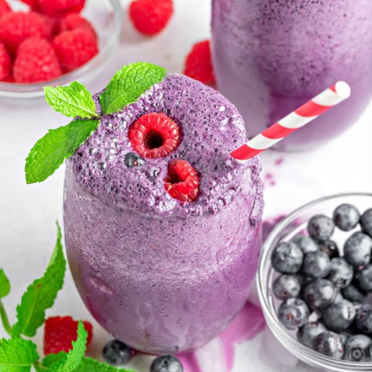 keto berry smoothie with a bowl of frozen berries next to it