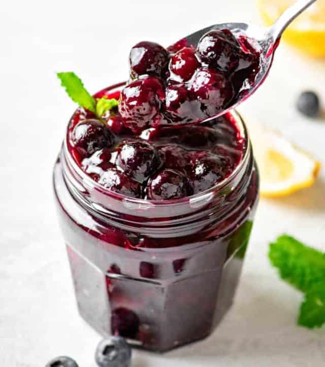 a close-up of sugar free blueberry sauce in a small jar
