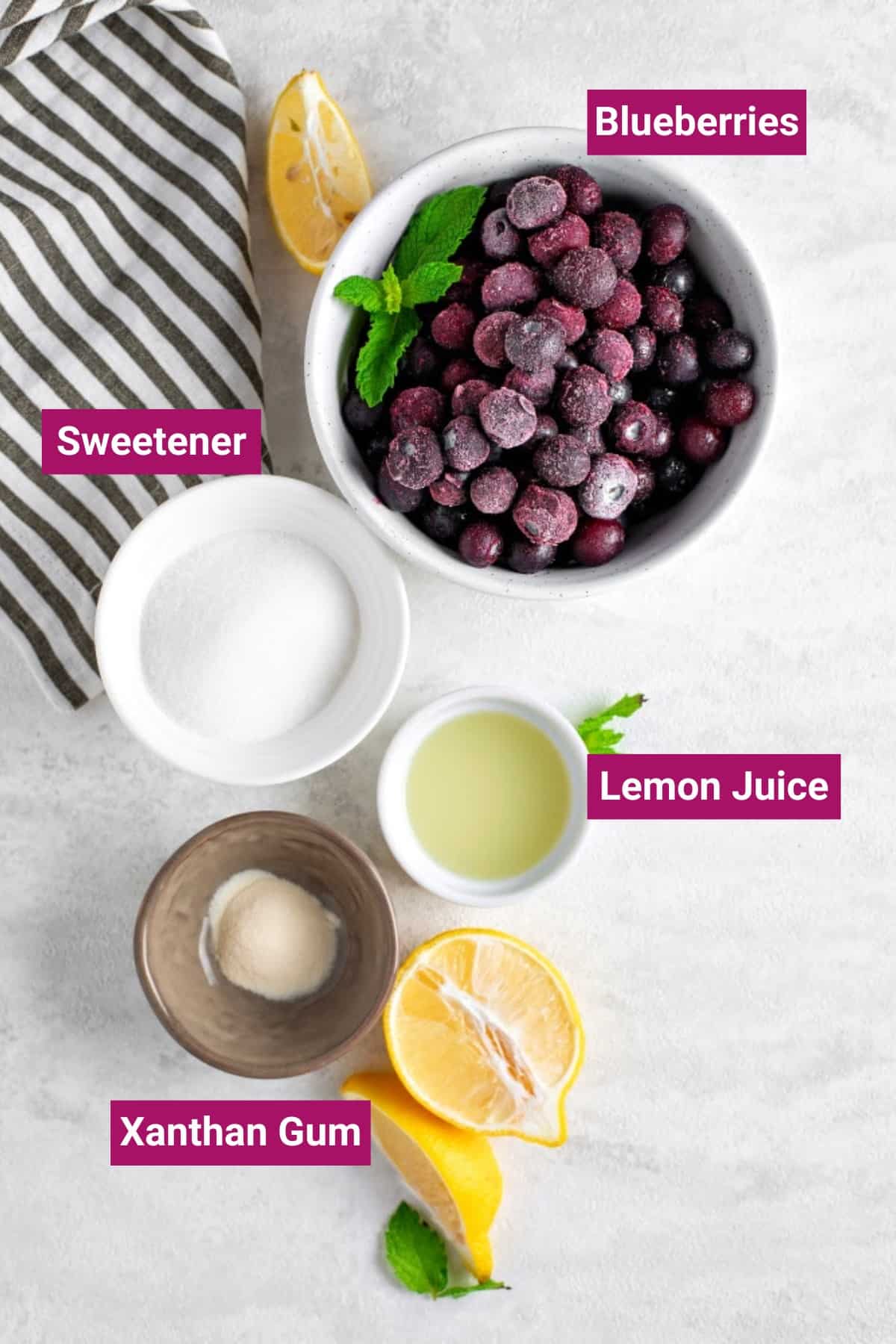 ingredients to make keto blueberry sauce in separate bowls: frozen blueberries, keto sweetener, lemon juice, and xanthum gum
