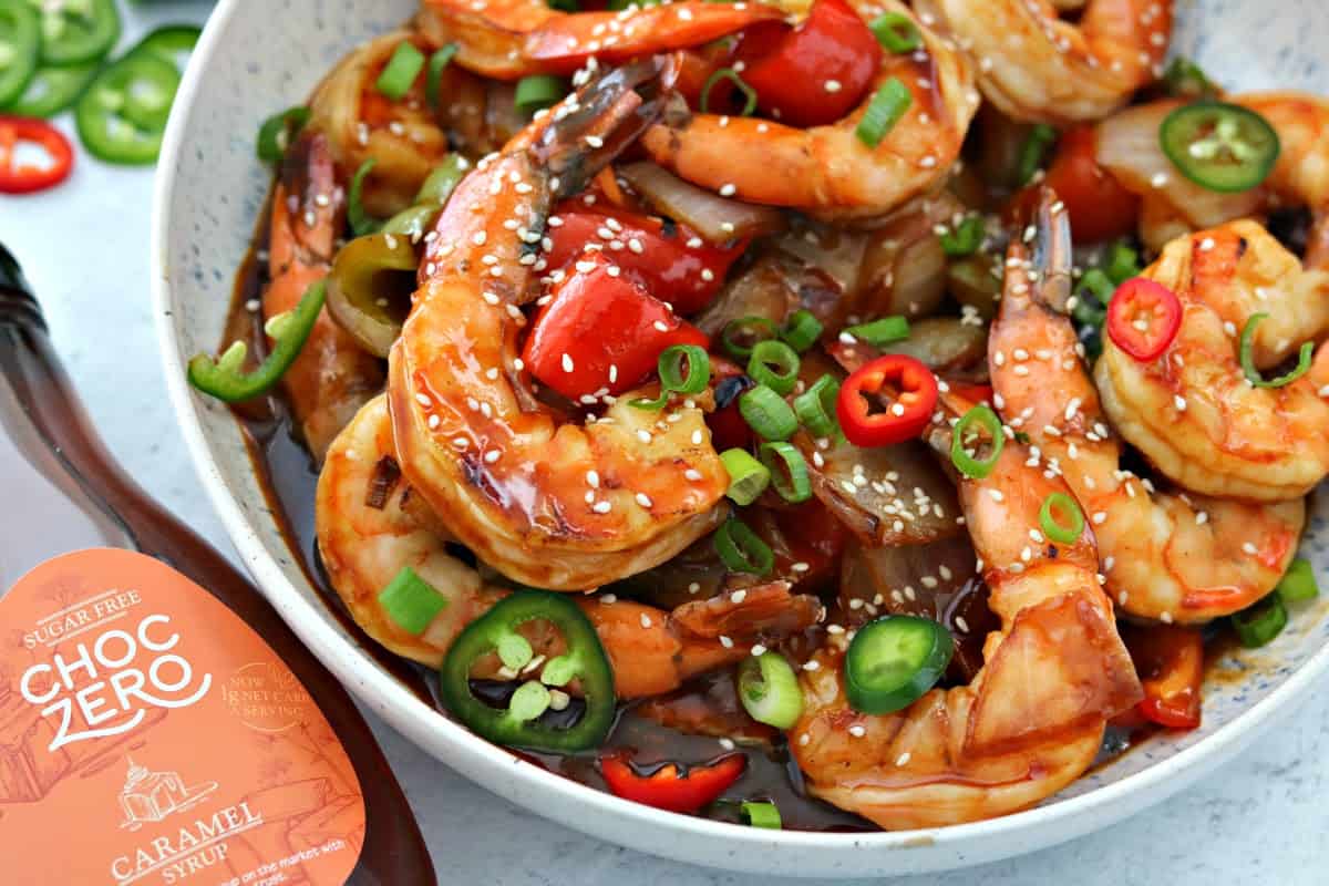 Keto Sweet and Sour Shrimp in a bowl next to ChocZero Sugar Free Syrup