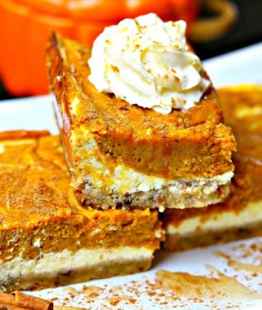 close-up of three keto pumpkin pie cheesecake bars stacked on top of each other