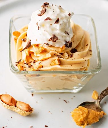 one glass of keto peanut butter mousse with whipped cream on top