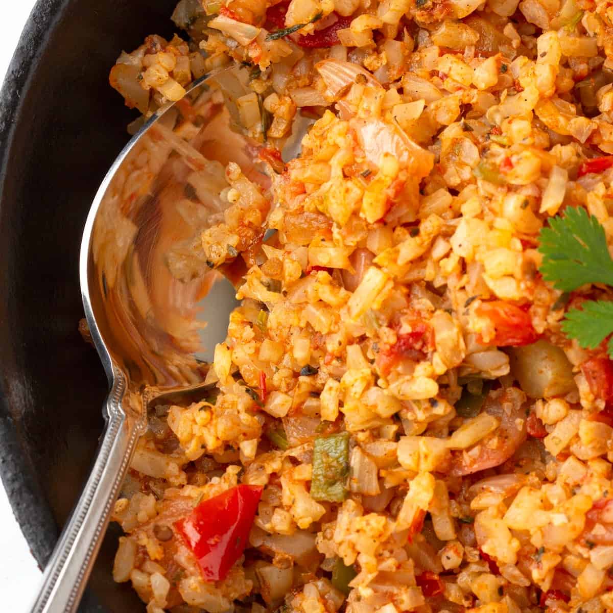 One pot of Spanish Mexican Cauliflower Rice with a spoon