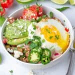 a breakfast taco bowl with a sunny side up egg and other toppings
