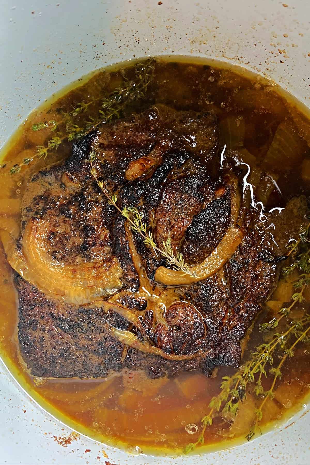 Overhead photo of the Ninja Foodi pot roast with gravy in the cooking pot