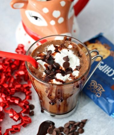 A cup of sugar free peppermint mocha topped with whipped cream and ChocZero baking chips