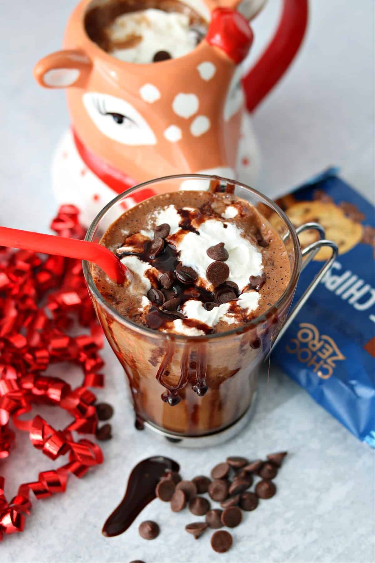 A cup of sugar free peppermint mocha topped with whipped cream and ChocZero baking chips
