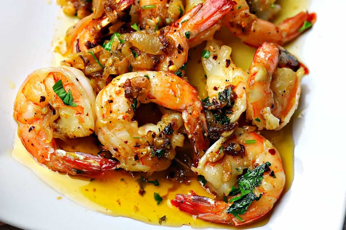A close-up of Shrimp Scampi on a white plate