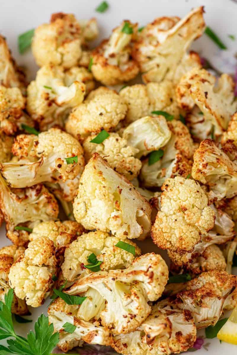 air fryer cauliflower on a plate topped with parsley
