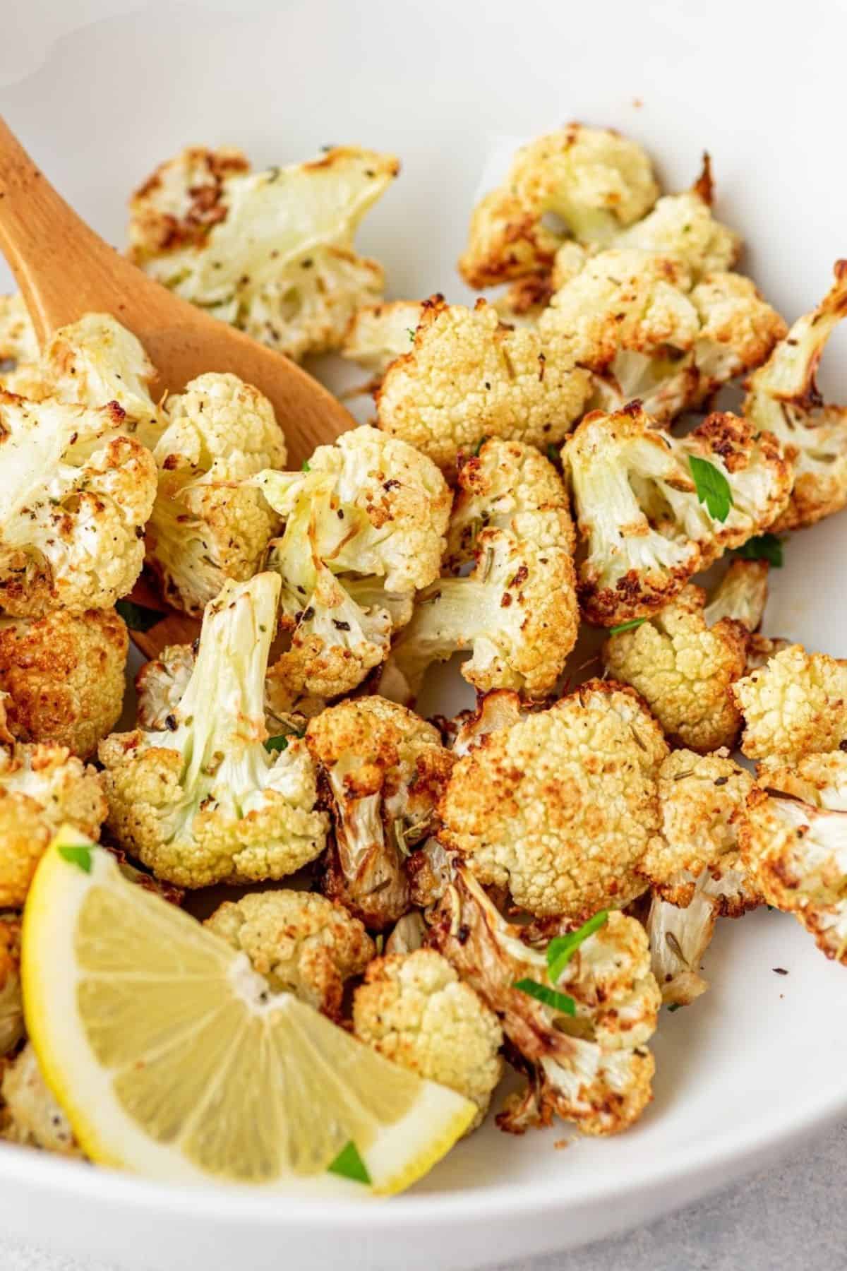 air fryer cauliflower in a bowl being prepared to use in another cauliflower recipe