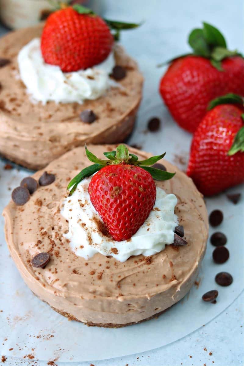 two keto no bake chocolate cheesecakes on a parchment paper