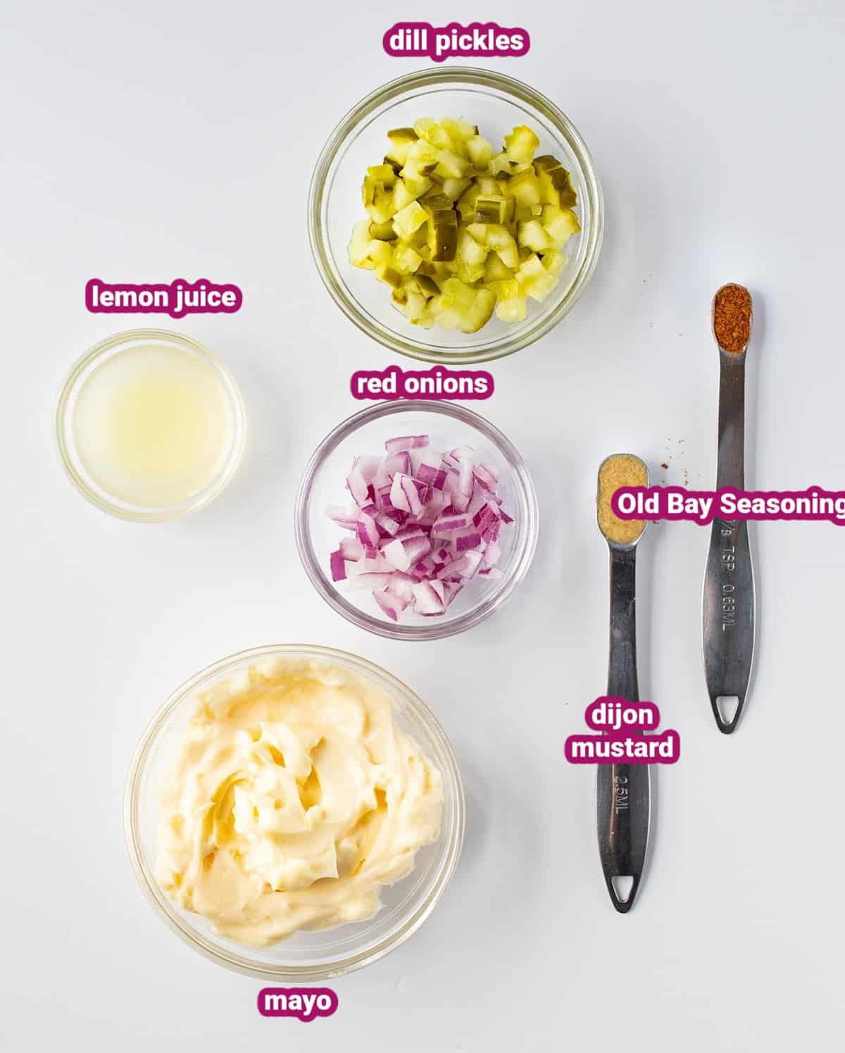 a photo of the ingredients for homemade keto tartar sauce like mayonnaise, chopped dill pickles, fresh lemon juice, red onions, dijon mustard, and old bay seasoning