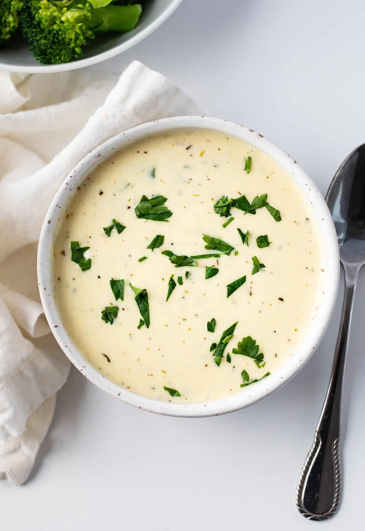 Keto Alfredo sauce in a bowl with parsley on top