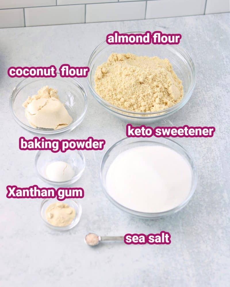 keto lemon pound cake dry ingredients with text to label the sea salt, almond flour, coconut flour, Xanthan Gum, baking powder and keto sweetener