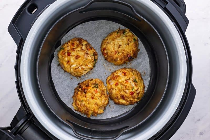 four air fryer crab cakes in the ninja foodi cooking basket