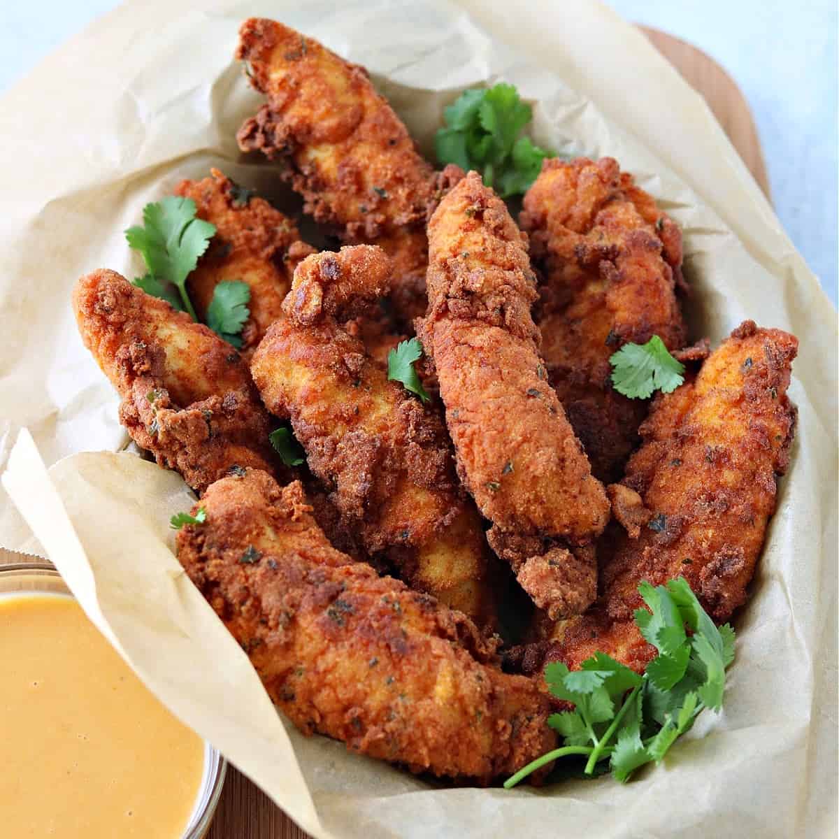 keto chicken tenders in a small pan with keto dipping sauce on the side