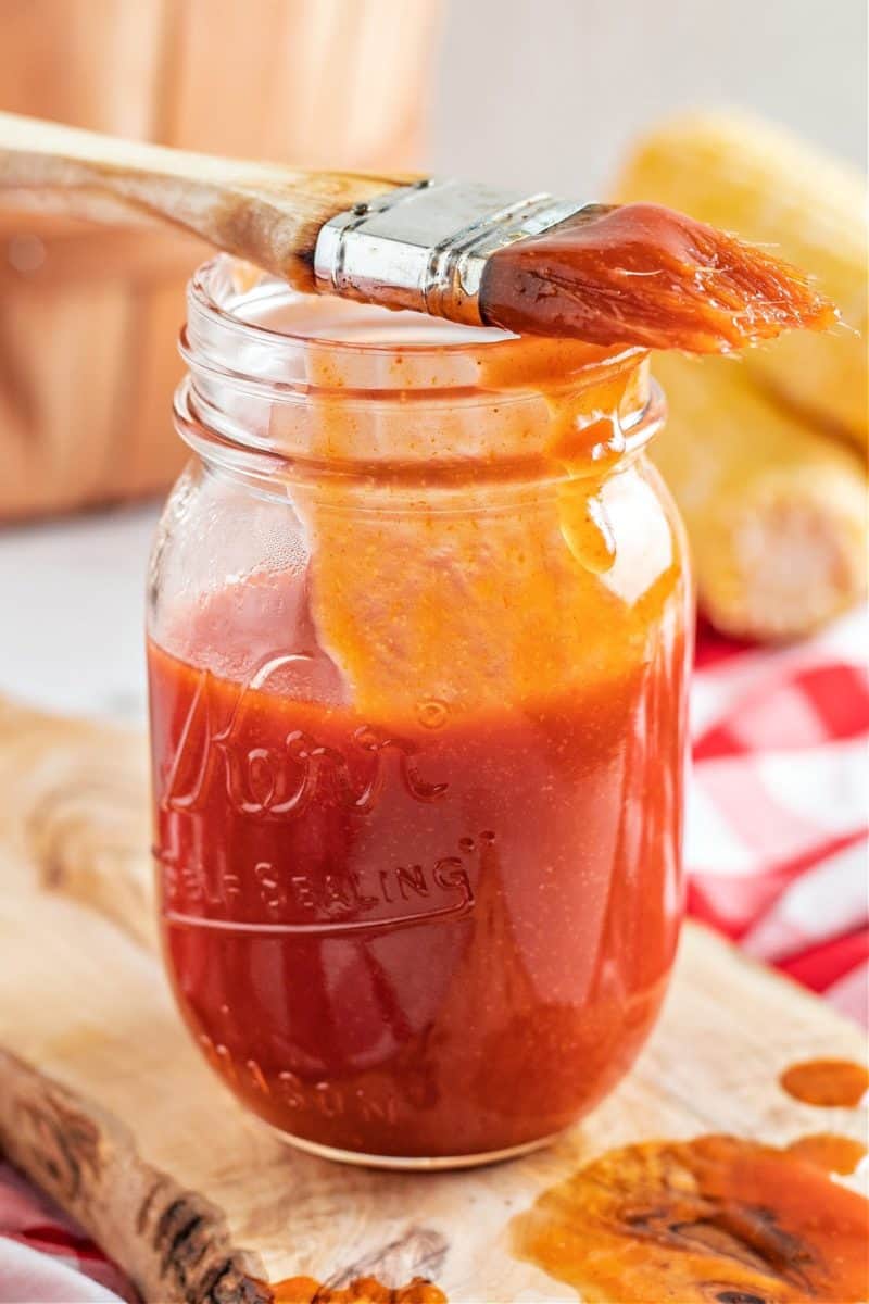 keto bbq sauce in a glass jar with a basting brush