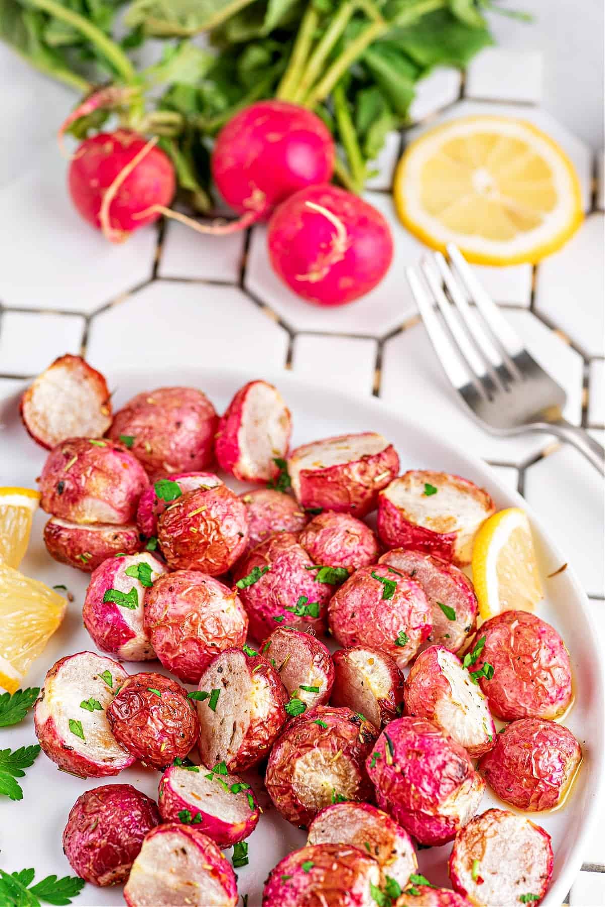 air fryer roasted radishes on a plate with lemon slices