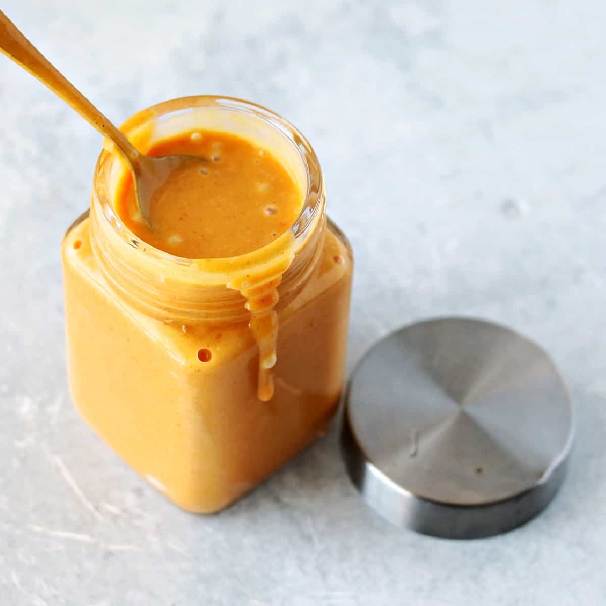 chick-fil-a sauce recipe in a glass jar with a spoon