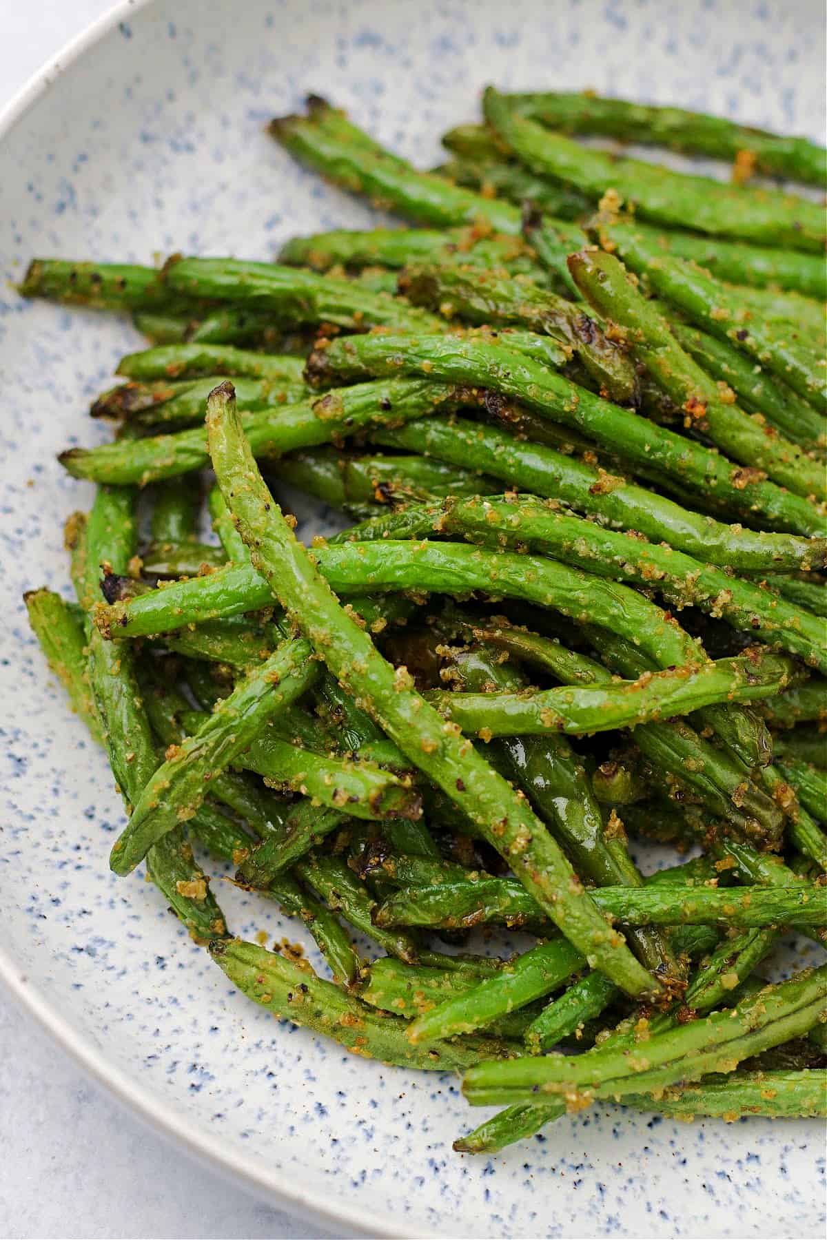 cooked crispy air fryer fresh green beans on a plate