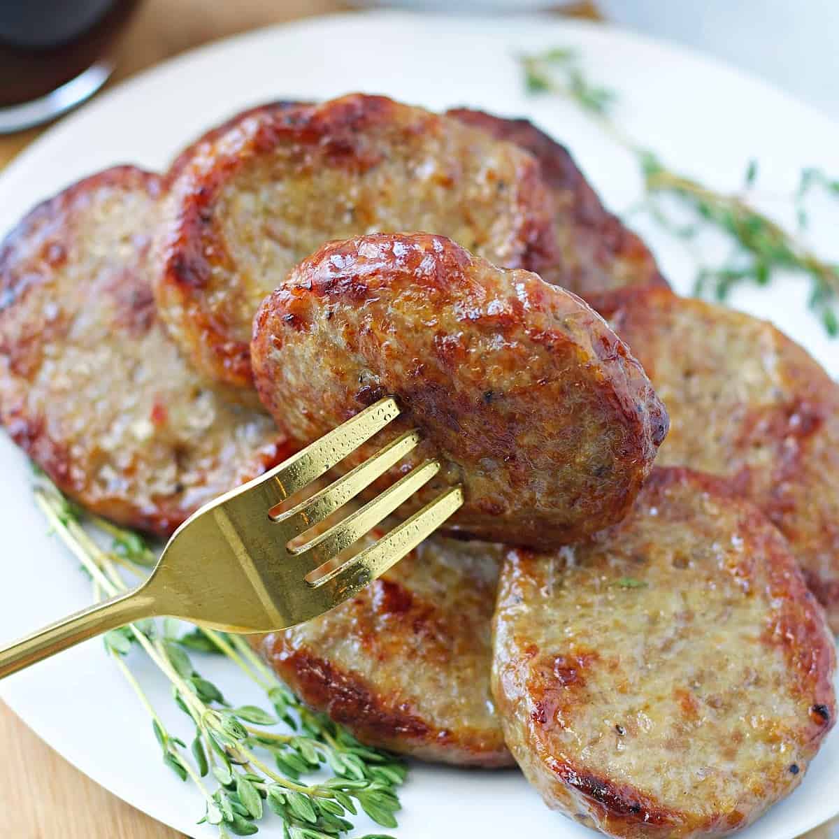 close up of browned air fryer sausage patties on a plate