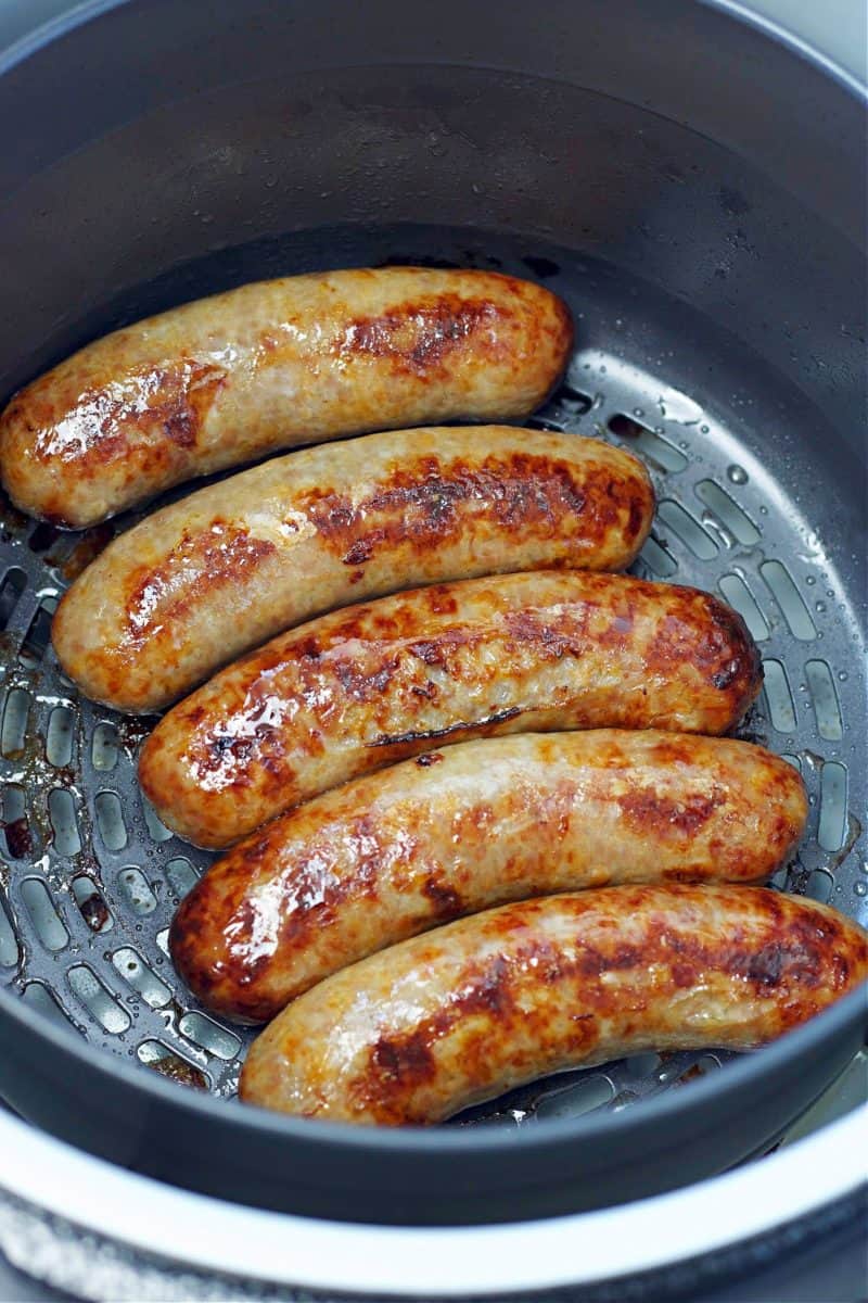 five bratwurst sausages in the Ninja Foodi cooking pot