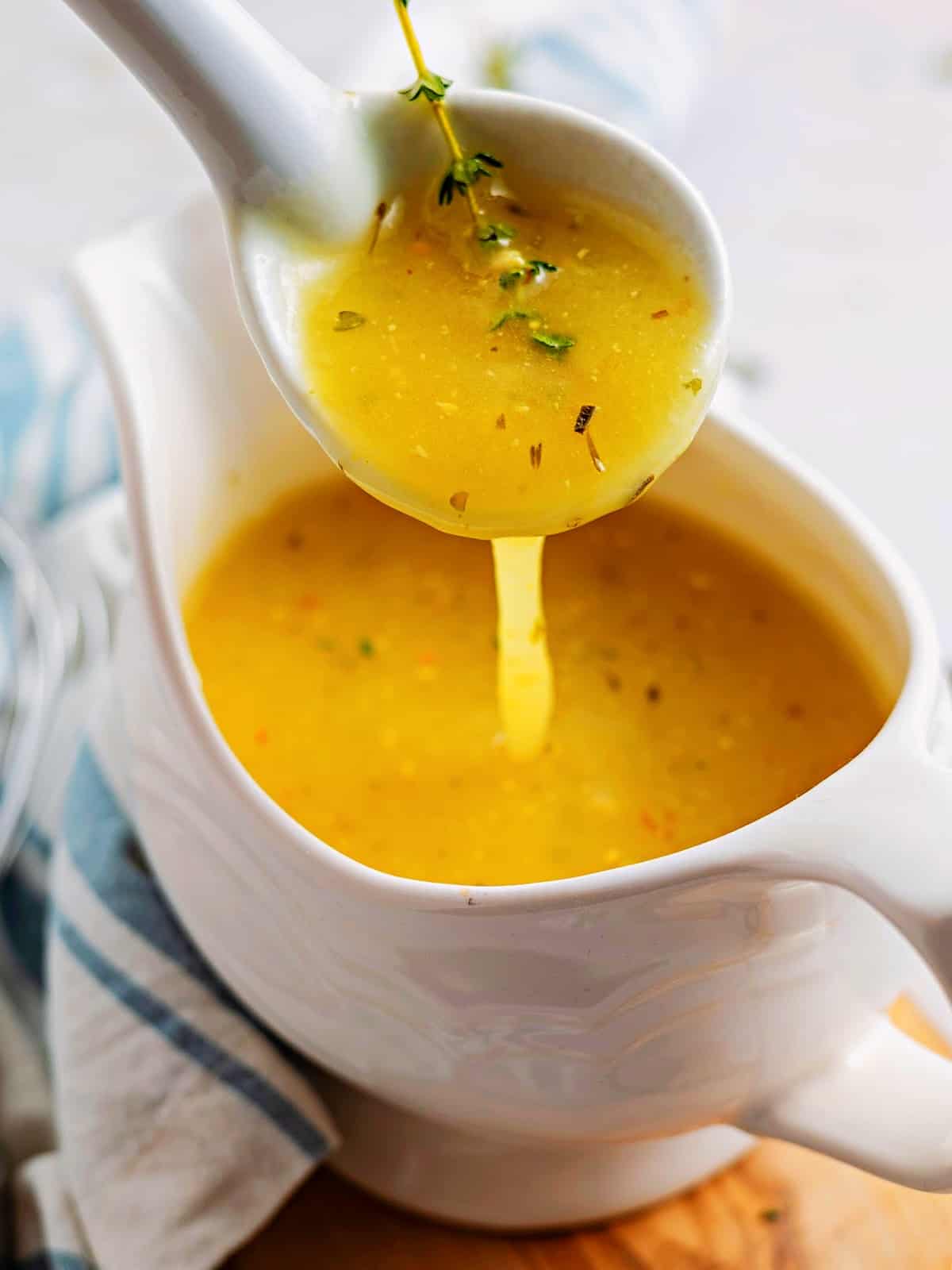 keto gravy in a sauce boat with a spoon