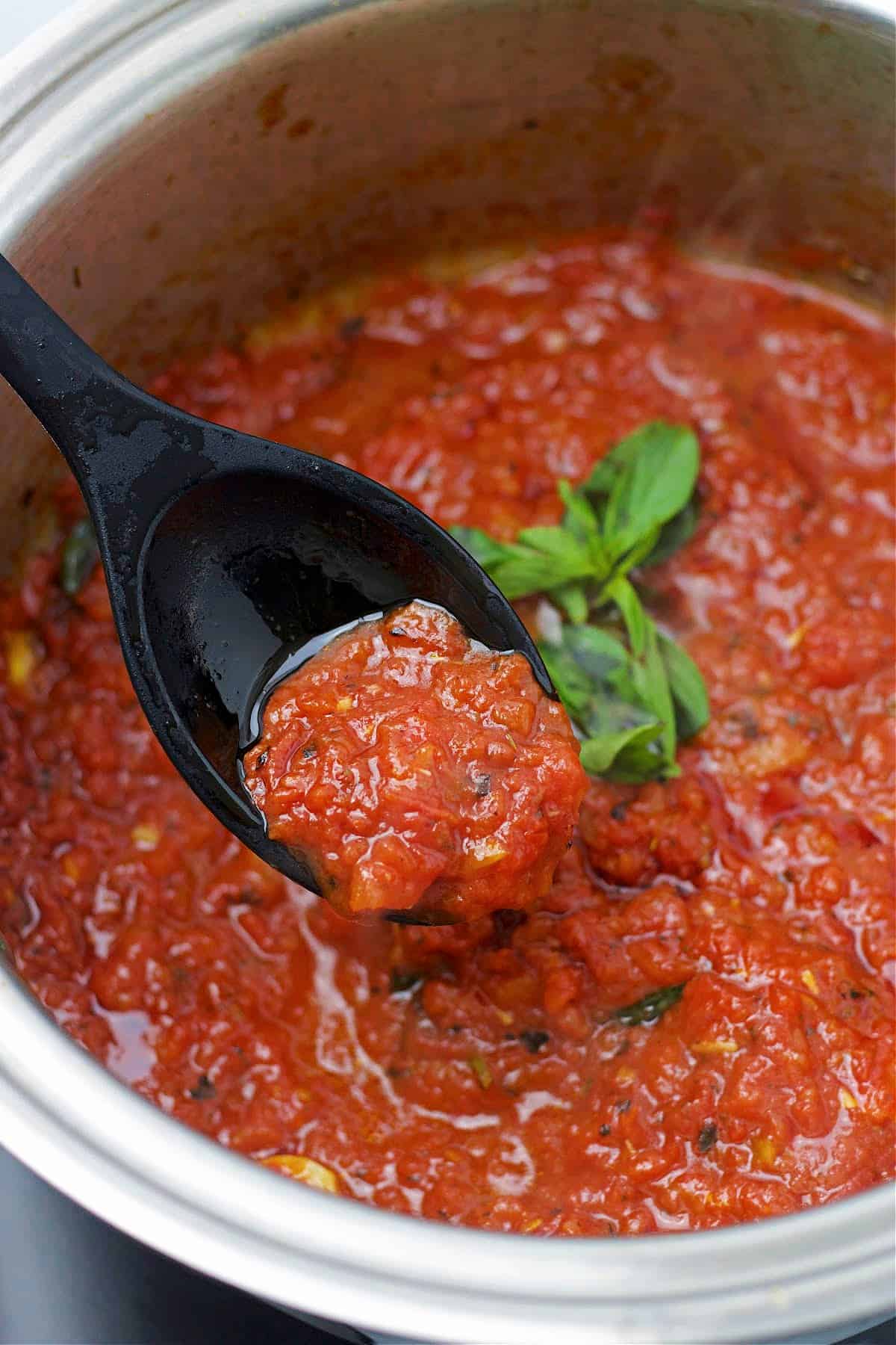 keto no sugar added marinara in a stainless steel pot with a spoon