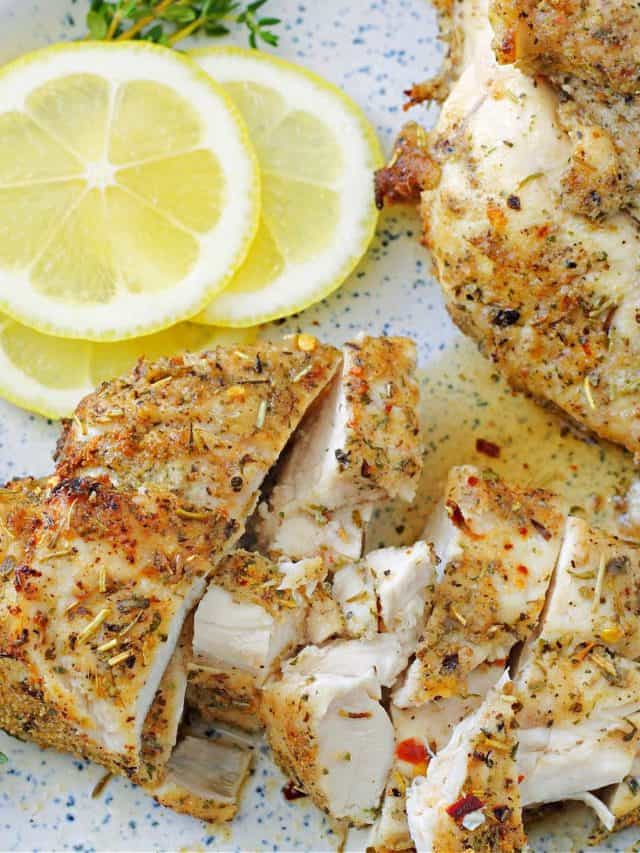 air fried chicken breasts on a plate with a squeeze of lemon