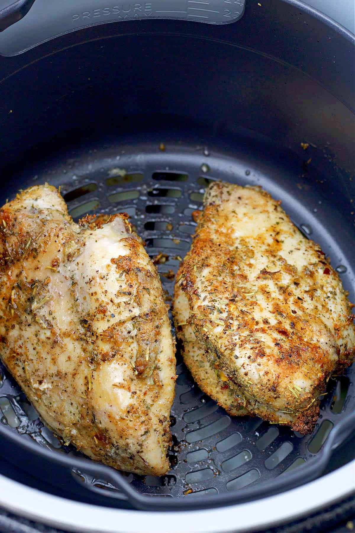 Make air fryer chicken breasts in 15 minutes that are juicy, flavorful, and never dry. Ideal for meal prep and last-minute chicken dinners. Cooked chicken breasts in the air fryer basket.