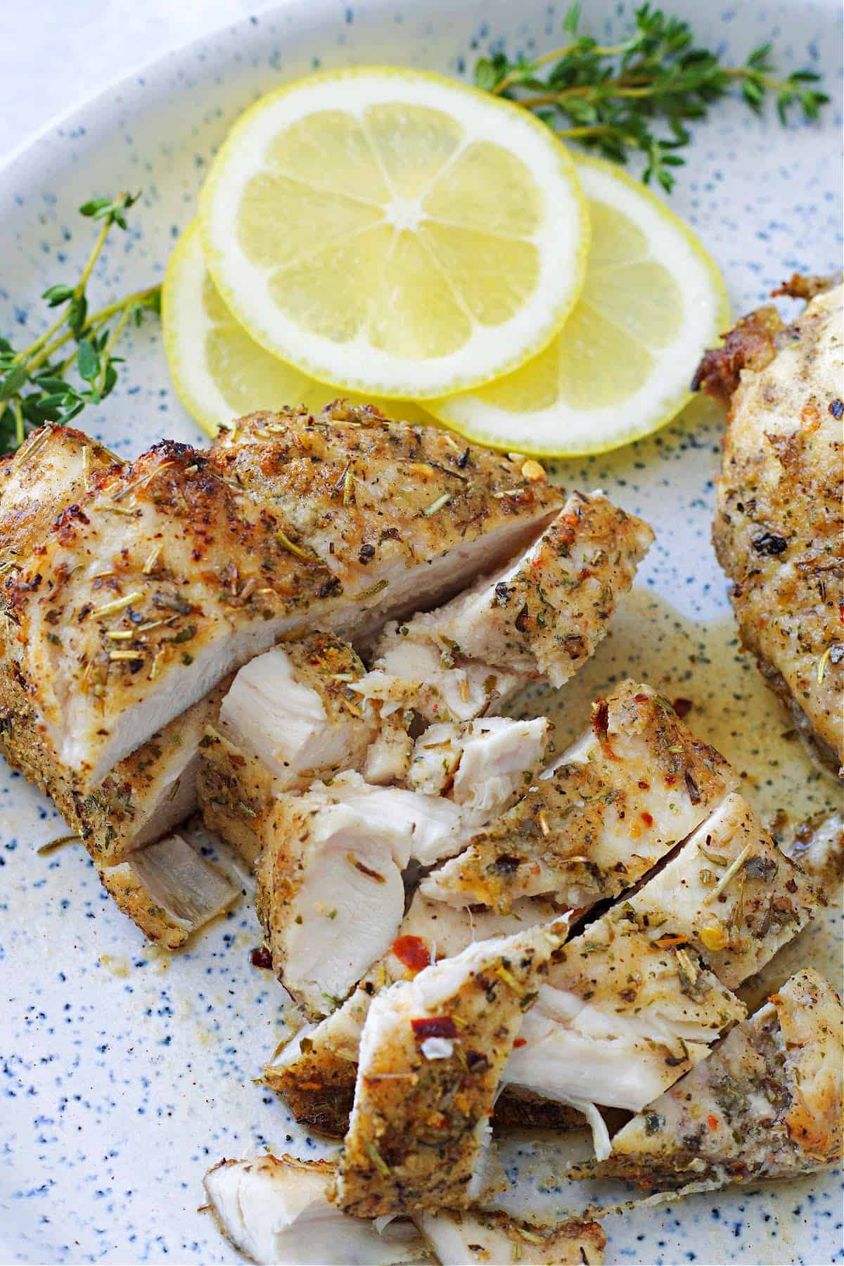 Make air fryer chicken breasts in 15 minutes that are juicy, flavorful, and never dry. Ideal for meal prep and last-minute chicken dinners. Sliced juicy air fryer chicken breast on a plate.
