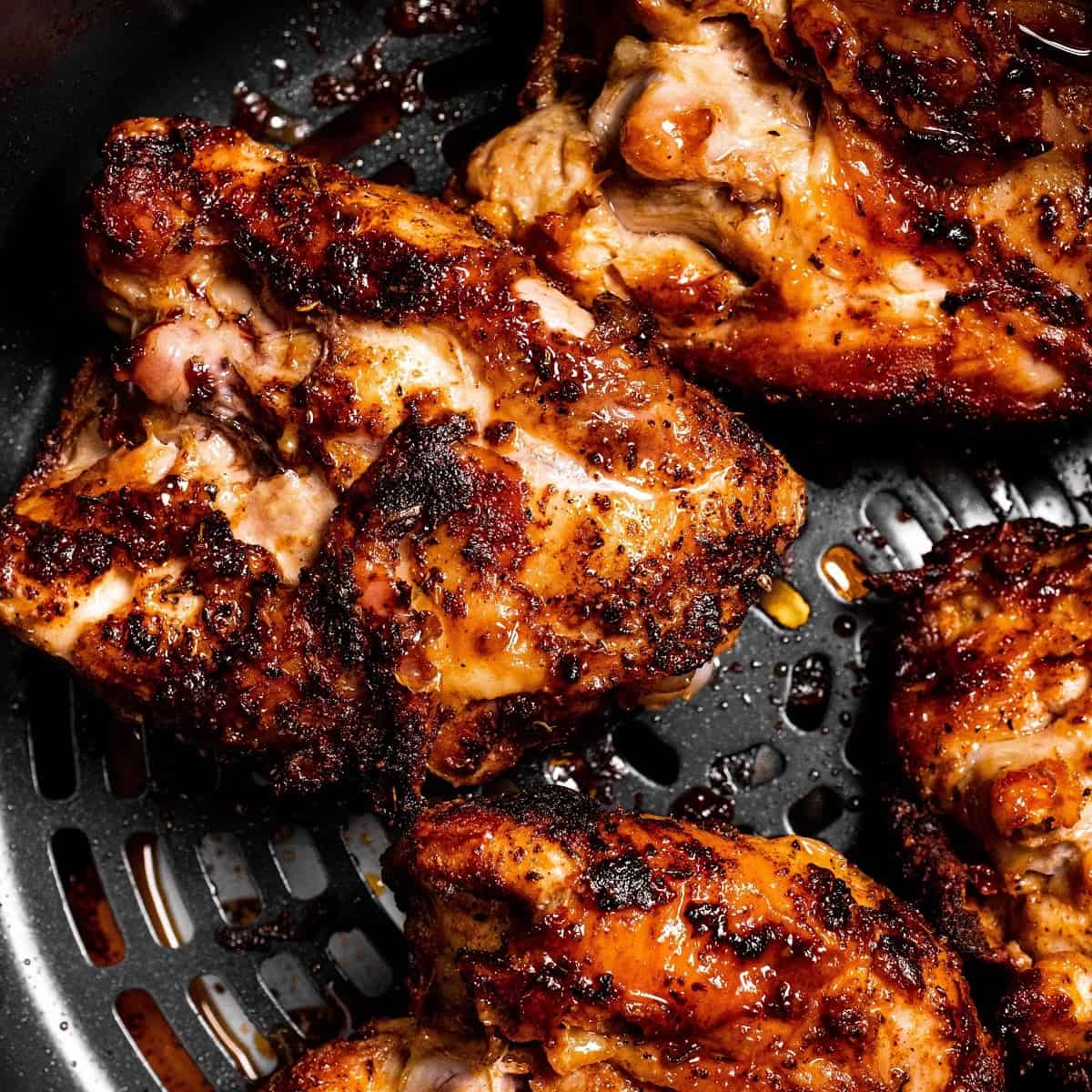 close up of three chicken thighs cooked in the Ninja Foodi air fryer