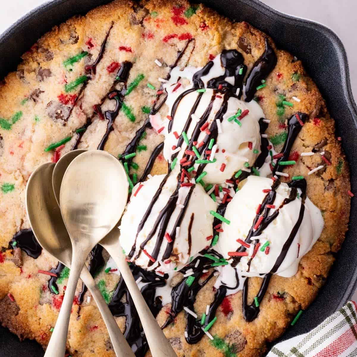 close up of Keto Christmas skillet cookie with ice cream and chocolate syrup