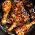 close up of air fryer roasted chicken drumsticks in the ninja foodi