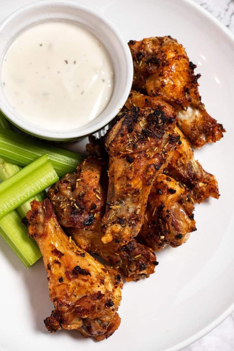 air fryer roasted wings on a plate with celery and dip