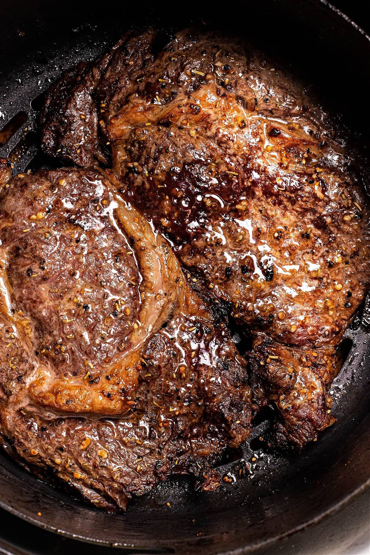 partially cooked steak in a preheat Ninja Foodi air fryer cooking basket