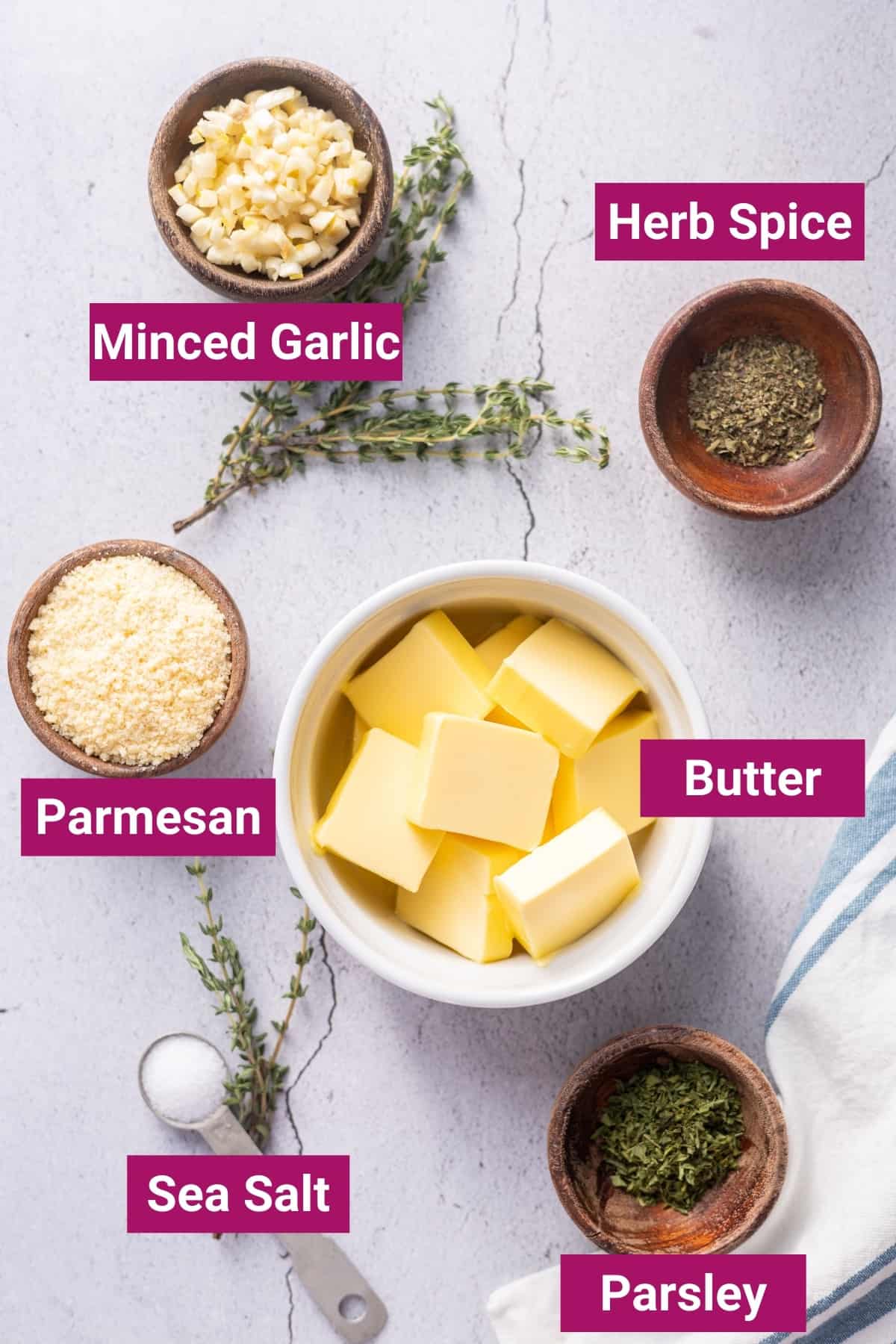 ingredients needed to make garlic herb butter for steak like salted butter, fresh herbs like parsley, salt, parmesan cheese, and minced garlic cloves.