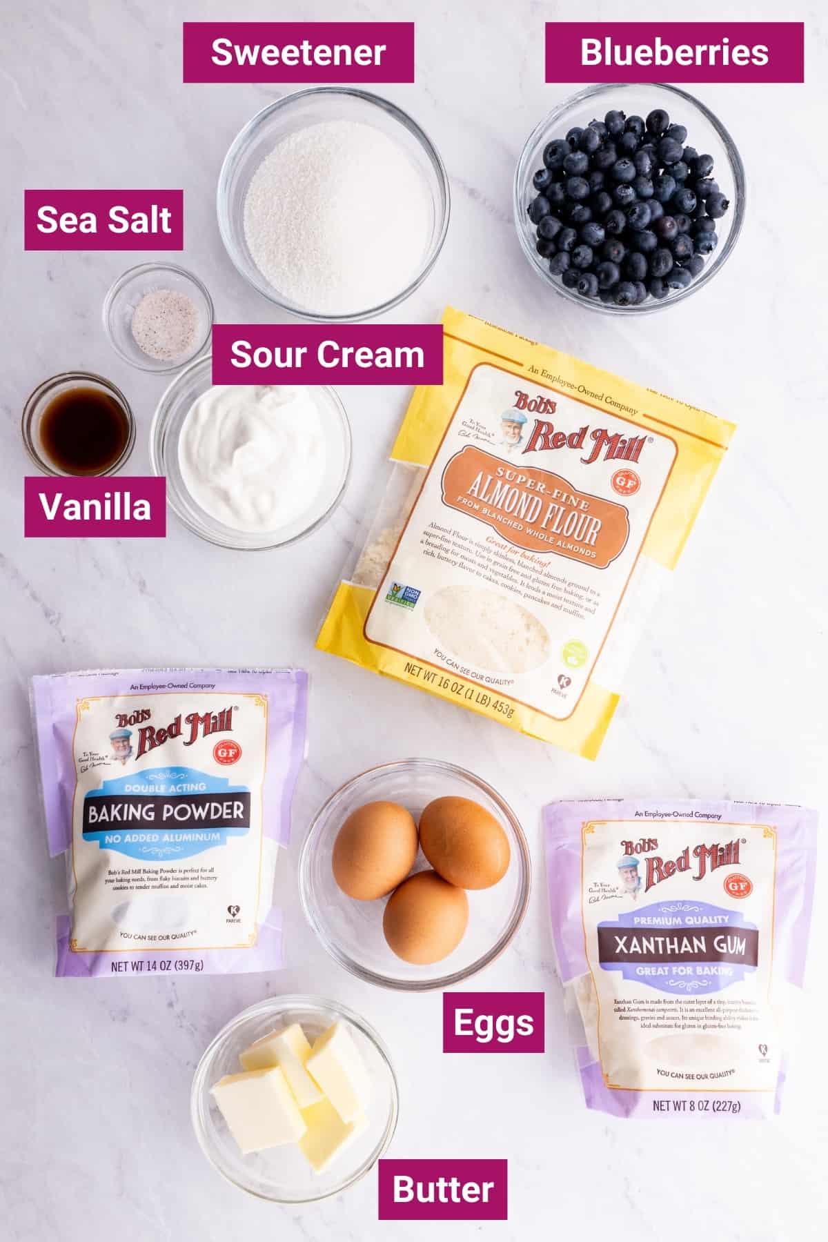 ingredients needed to make the best keto blueberry muffins with almond flour like fresh blueberries, sour cream, keto sweetened, baking powder, Xanthan Gum, eggs, butter, vanilla, and sea salt