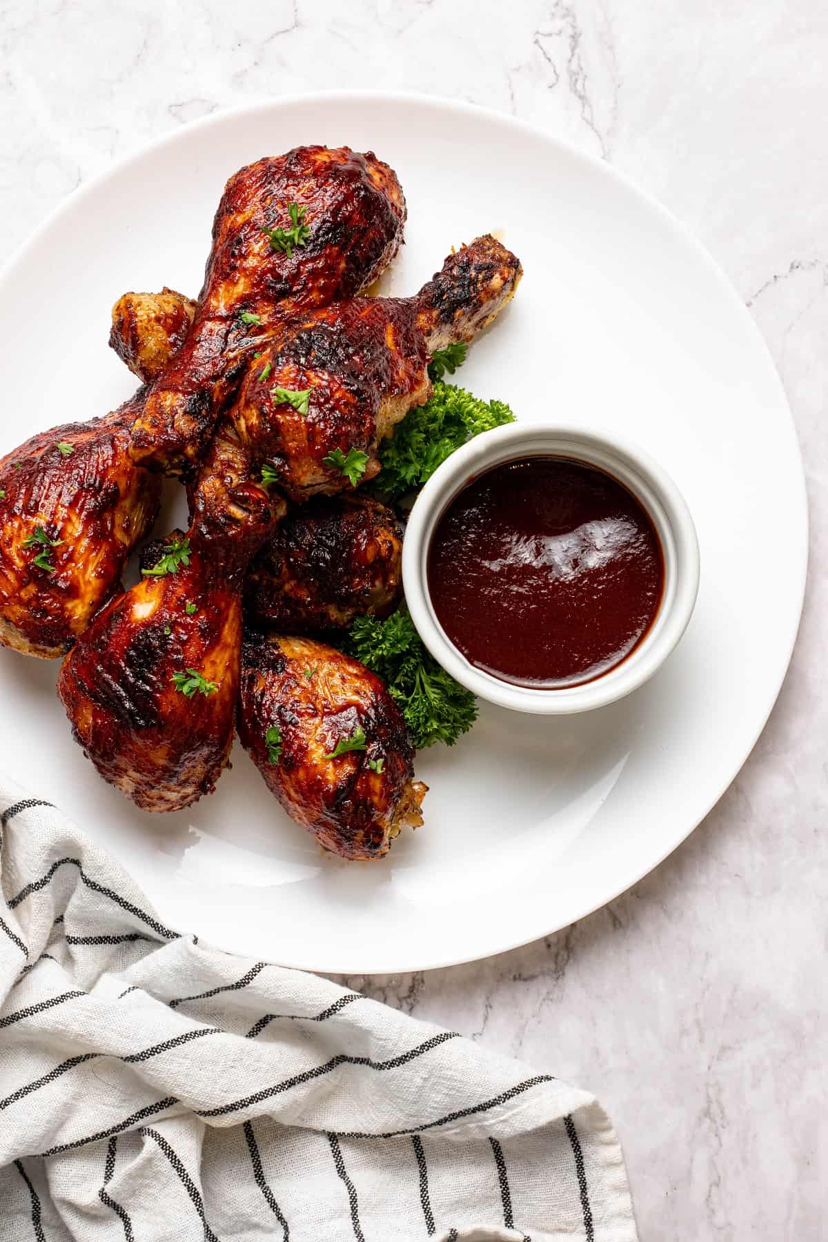 Air Fryer BBQ Drumsticks in a plate with bbq sauce