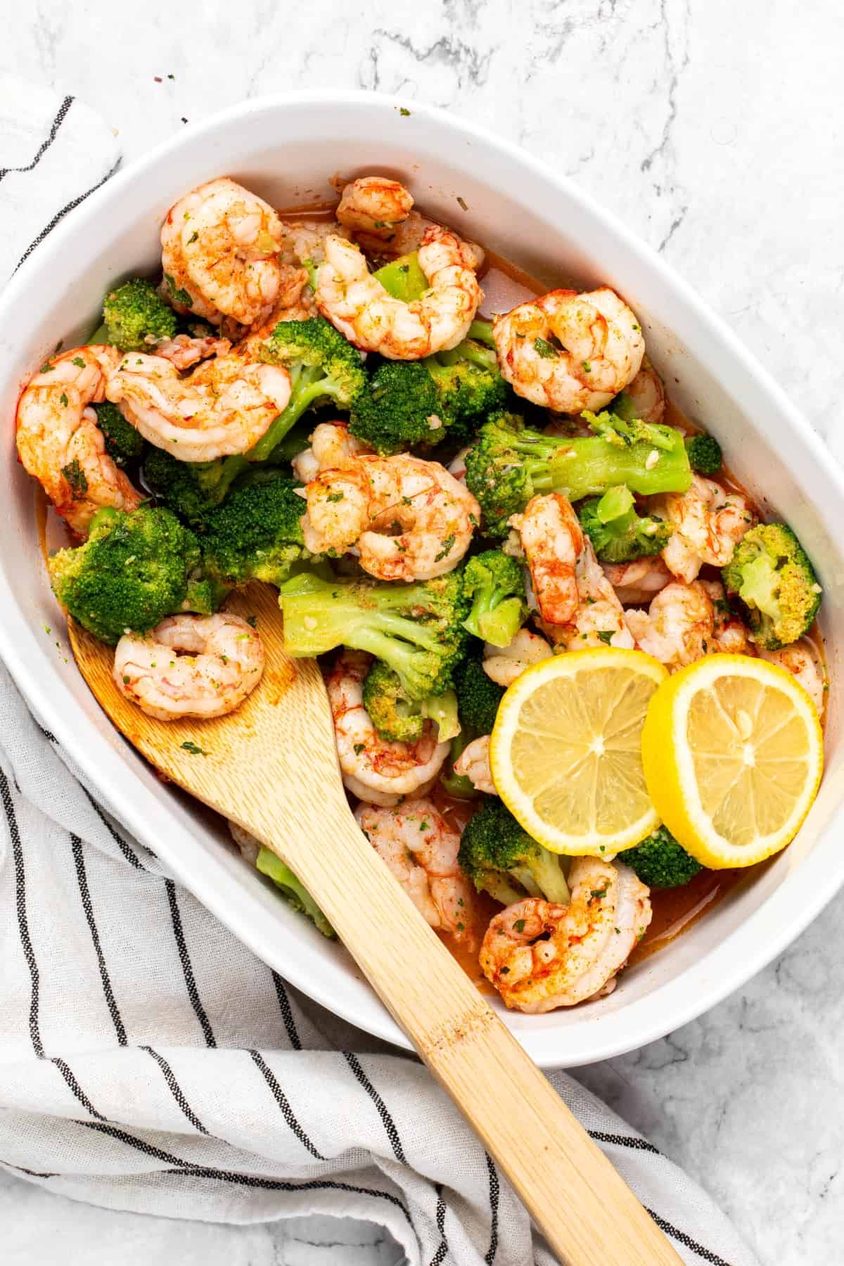 Air Fryer Cajun Shrimp & Broccoli on a large bowl with wooden spoon
