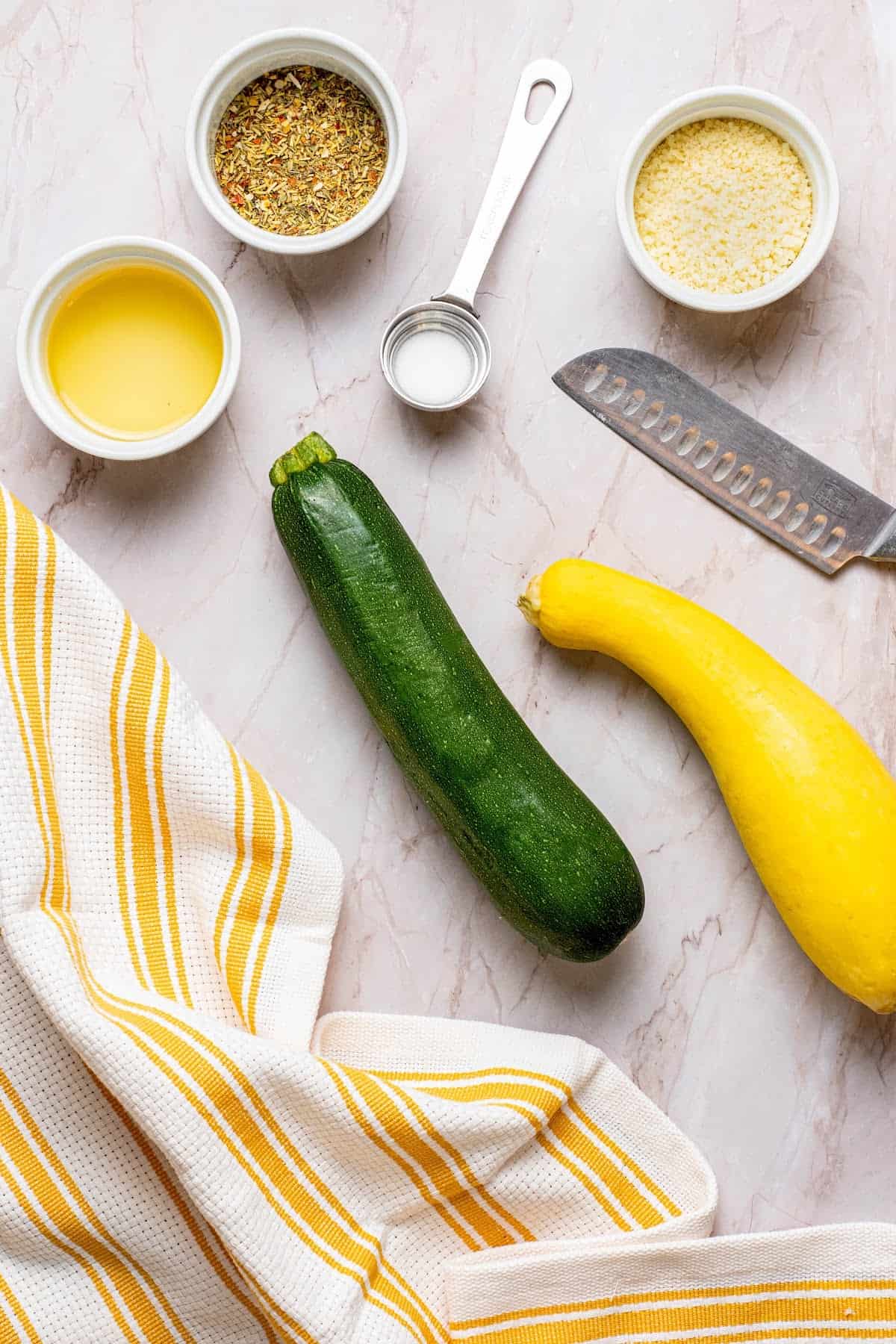yellow squash, zucchini squash, avocado oil, Parmesan Cheese, sea salt and herb seasoning in bowls