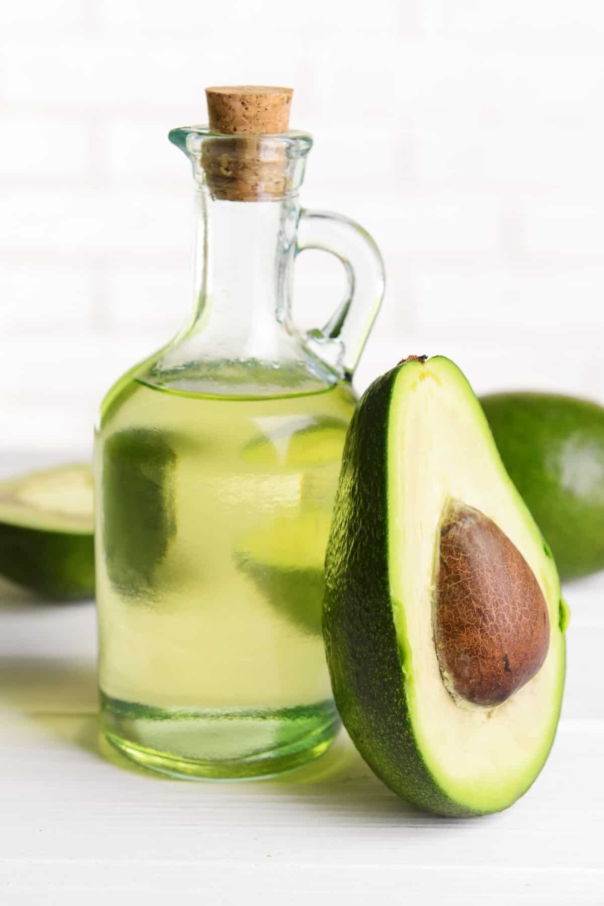 avocado oil in a glass jar with slices of avocado