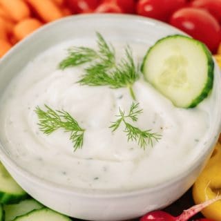 Greek yogurt ranch in a bowl surrounded by vegetables