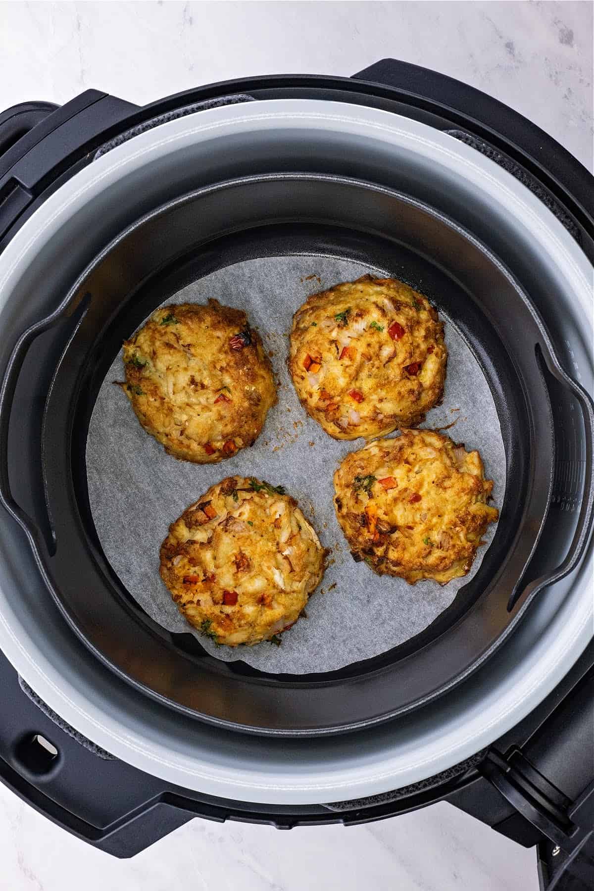 air fryer crab cakes in the Ninja Foodi with parchment paper